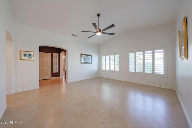 10371 W Pontiac Dr, Peoria, AZ 85382 - spare room featuring arched walkways, ceiling fan, lofted ceiling, light tile patterned flooring, and baseboards