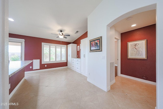 10371 W Pontiac Dr, Peoria, AZ 85382 - unfurnished room featuring arched walkways, a ceiling fan, lofted ceiling, light tile patterned floors, and baseboards
