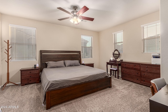 bedroom with ceiling fan and light carpet