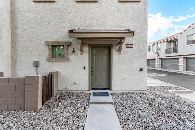 view of exterior entry featuring a garage