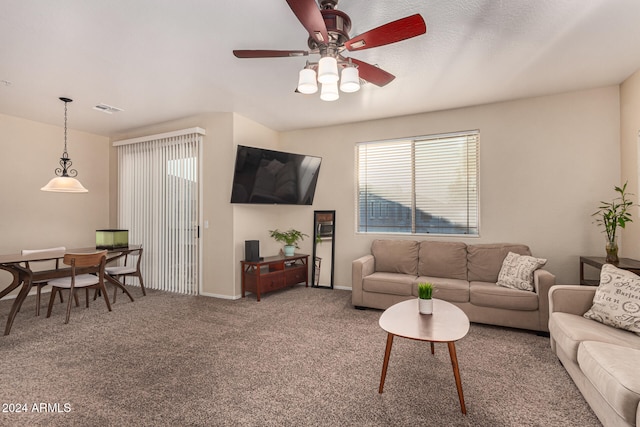 carpeted living room featuring ceiling fan