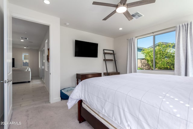 bedroom with light hardwood / wood-style floors and ceiling fan