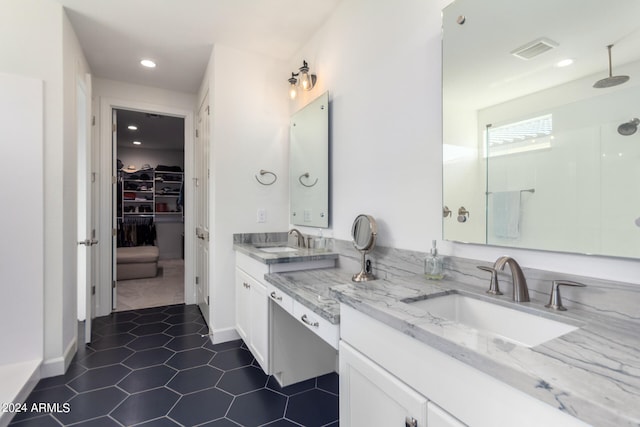 bathroom with vanity, a shower, and tile patterned flooring