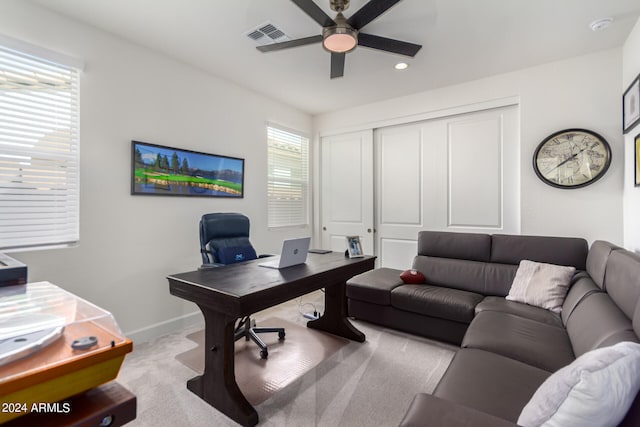 office featuring ceiling fan and light carpet