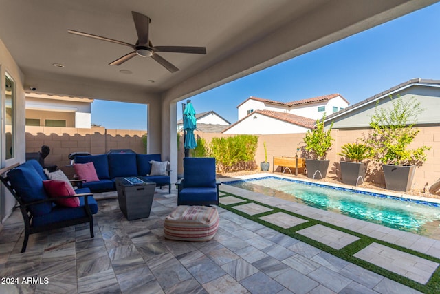 view of patio featuring outdoor lounge area, ceiling fan, a fenced in pool, and pool water feature