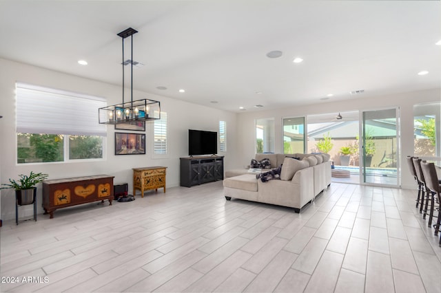 living room featuring light wood-type flooring and a chandelier