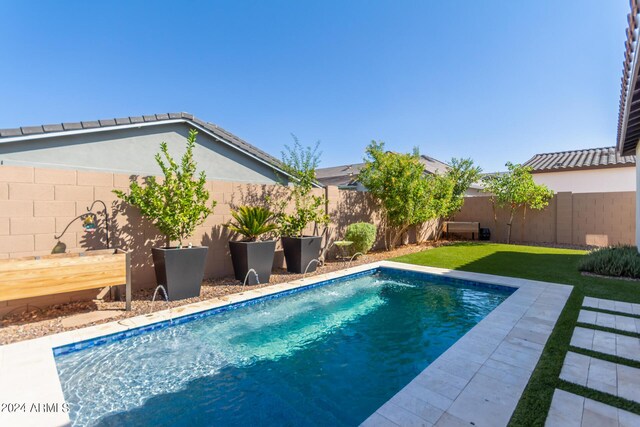 view of yard with a fenced in pool and a patio area