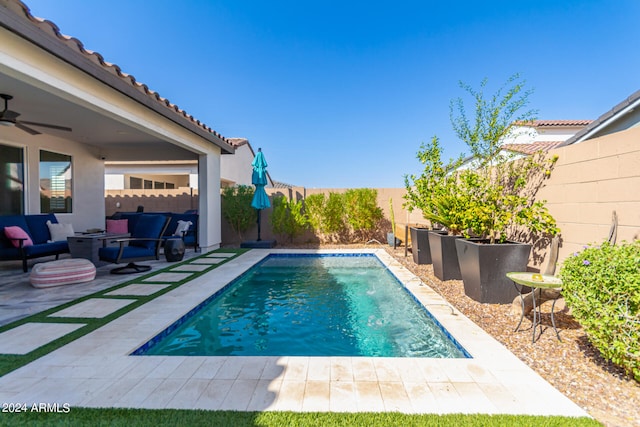 view of swimming pool with ceiling fan, outdoor lounge area, and a patio