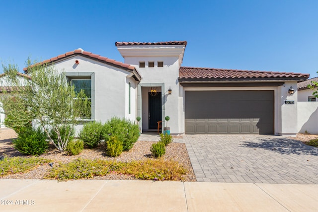 mediterranean / spanish-style house with a garage