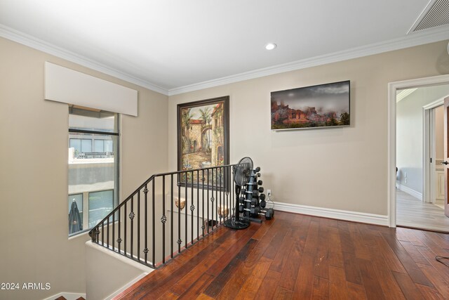 hall featuring crown molding, a wealth of natural light, and hardwood / wood-style floors