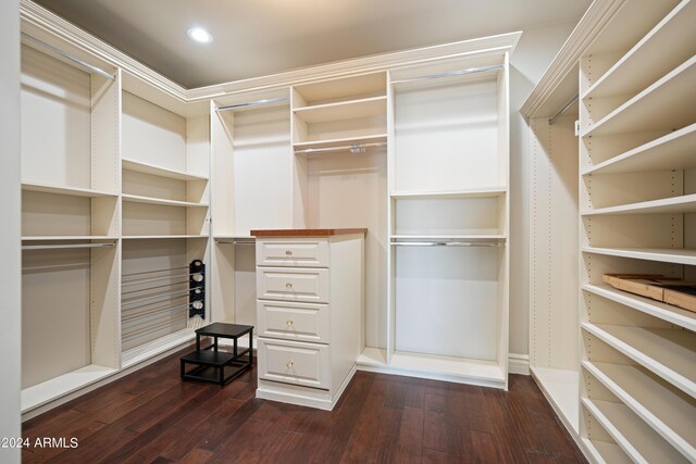 spacious closet with dark hardwood / wood-style floors