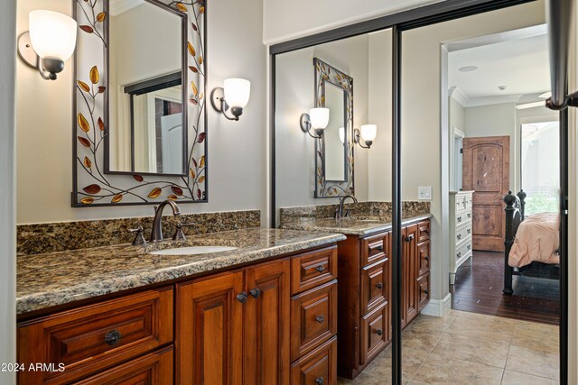 bathroom with hardwood / wood-style flooring, ornamental molding, and vanity