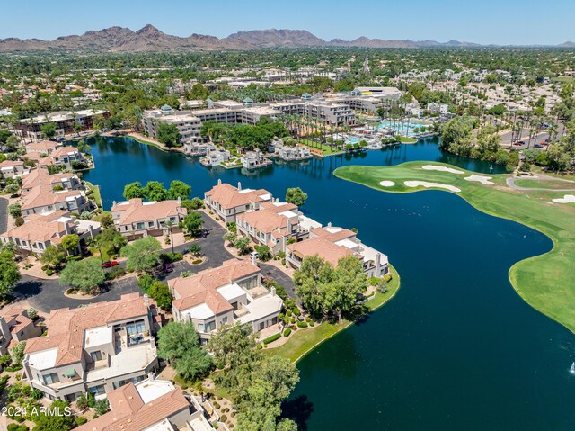 birds eye view of property with a water and mountain view