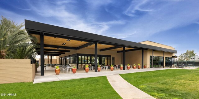 view of property's community featuring a patio area and a yard