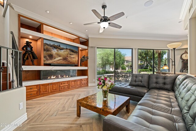 living room featuring crown molding, light parquet floors, and ceiling fan