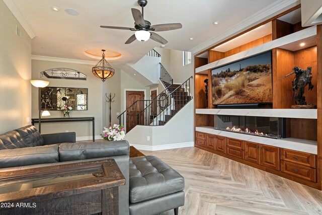 living room with ornamental molding, light parquet flooring, and ceiling fan