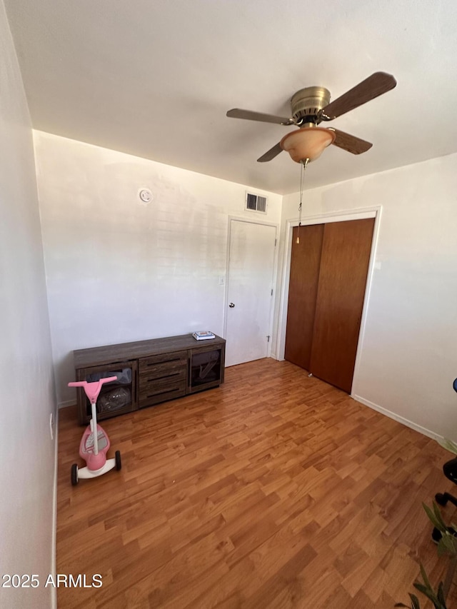 2115 W Myrtle Ave, Phoenix, AZ 85021 - unfurnished bedroom with wood finished floors, ceiling fan, and baseboards