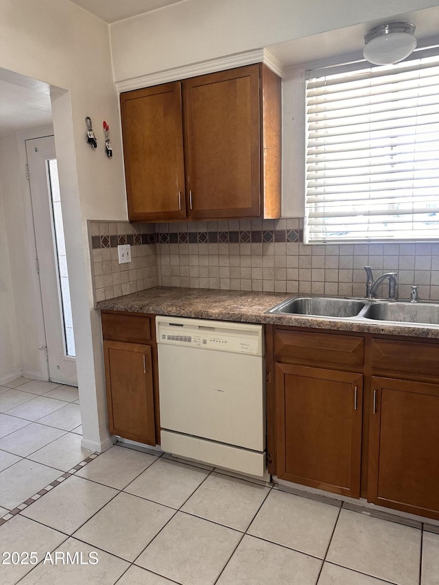 2115 W Myrtle Ave, Phoenix, AZ 85021 - kitchen featuring white dishwasher, a sink, light tile patterned floors, tasteful backsplash, and brown cabinets