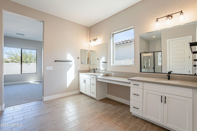 bathroom featuring vanity and a shower with door