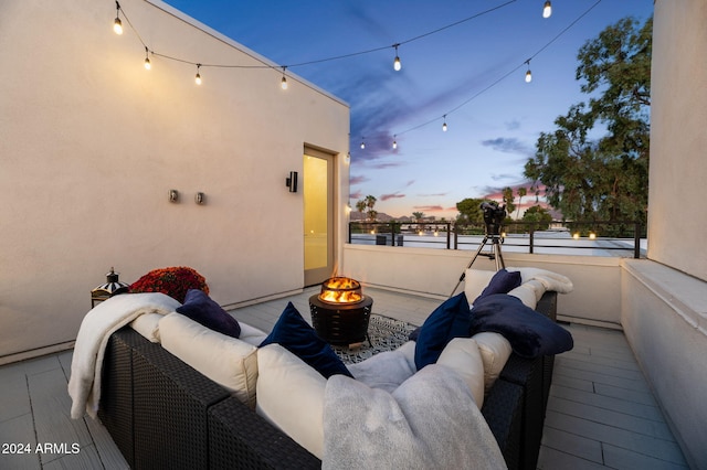 5151 N 13th Pl Unit 4, Phoenix, AZ 85014 - patio terrace at dusk featuring an outdoor living space with a fire pit and a balcony