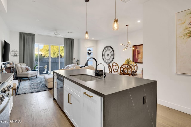 5151 N 13th Pl Unit 4, Phoenix, AZ 85014 - kitchen with a sink, dark countertops, open floor plan, light wood-style floors, and recessed lighting