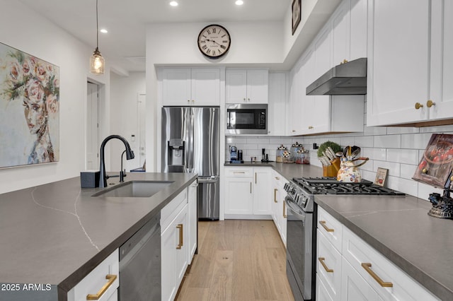 5151 N 13th Pl Unit 4, Phoenix, AZ 85014 - kitchen featuring appliances with stainless steel finishes, a sink, under cabinet range hood, dark countertops, and recessed lighting