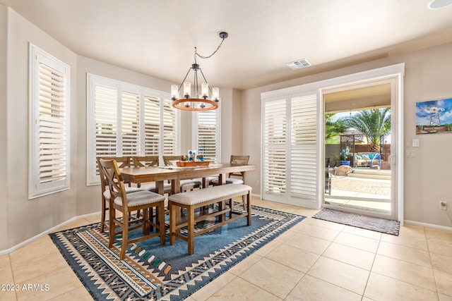 tiled dining room featuring a notable chandelier