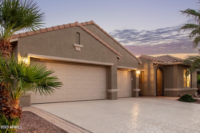 mediterranean / spanish-style house featuring a garage