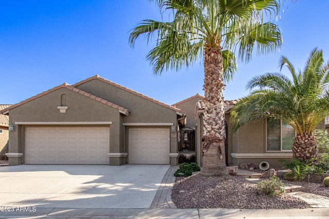 mediterranean / spanish-style house with a garage