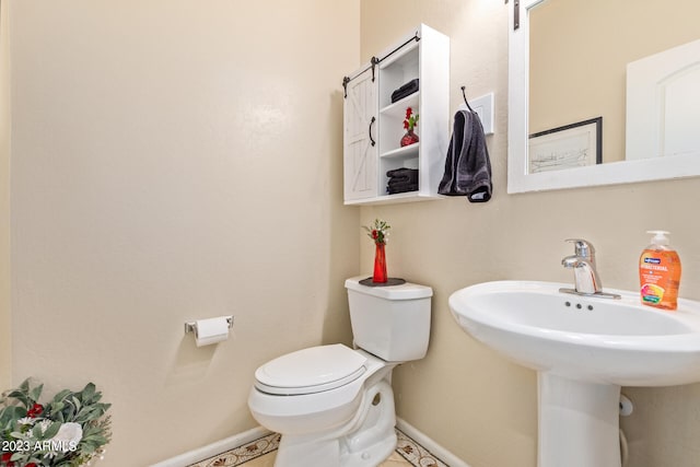 bathroom featuring tile patterned floors, toilet, and sink