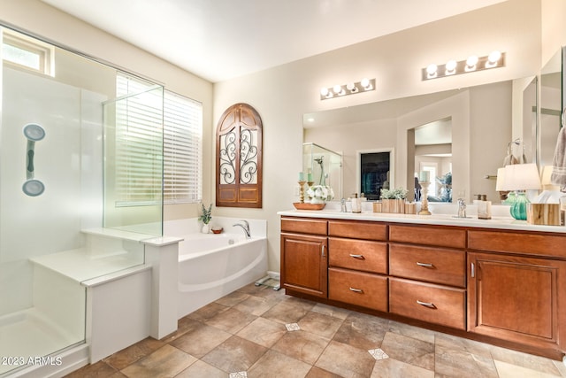 bathroom featuring separate shower and tub and vanity