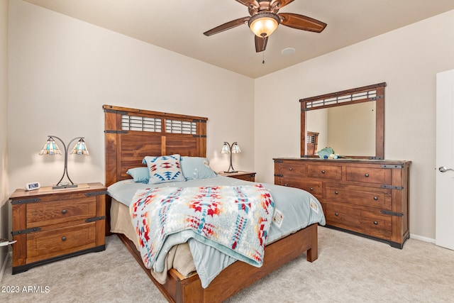 bedroom featuring light colored carpet and ceiling fan