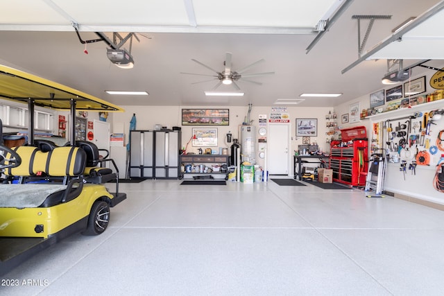 garage featuring a garage door opener, water heater, and ceiling fan