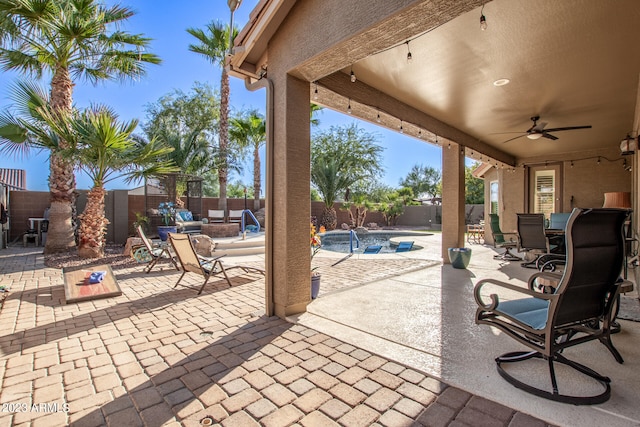 view of patio / terrace featuring ceiling fan and a fenced in pool