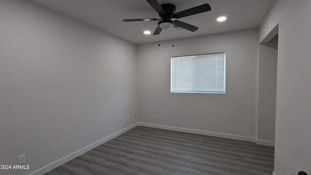 unfurnished room with dark hardwood / wood-style flooring and ceiling fan