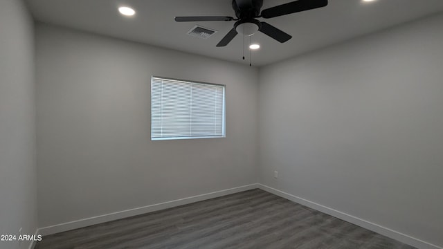 unfurnished room with ceiling fan and dark wood-type flooring