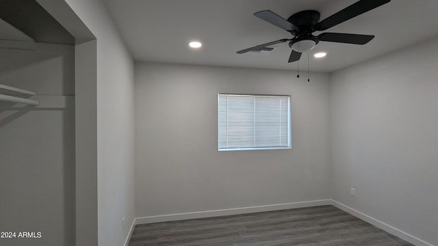 unfurnished room featuring ceiling fan and dark hardwood / wood-style floors