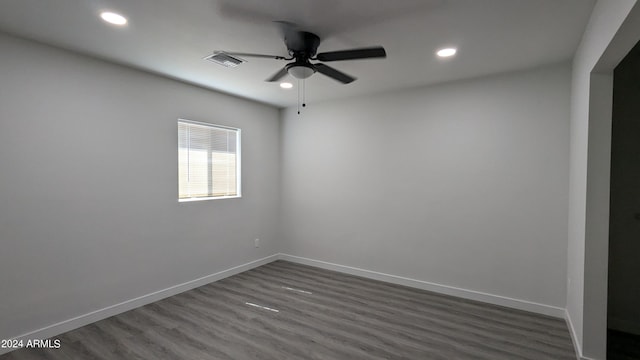 unfurnished room with ceiling fan and dark hardwood / wood-style flooring