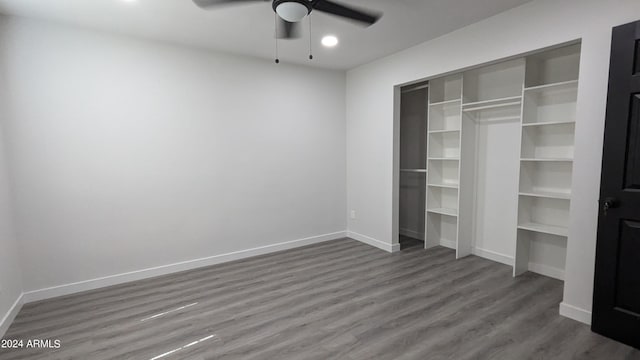 unfurnished bedroom featuring ceiling fan, dark wood-type flooring, and a closet