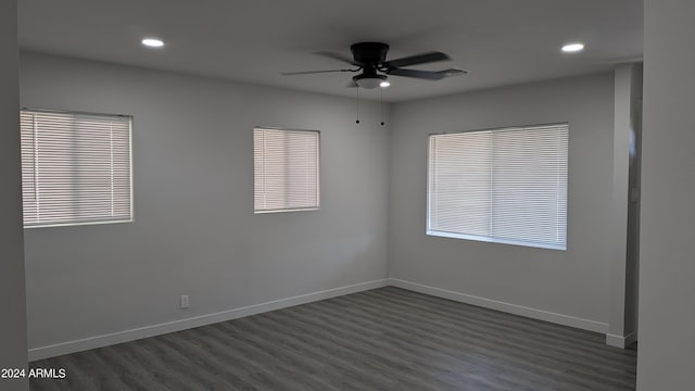 empty room with ceiling fan and dark hardwood / wood-style flooring