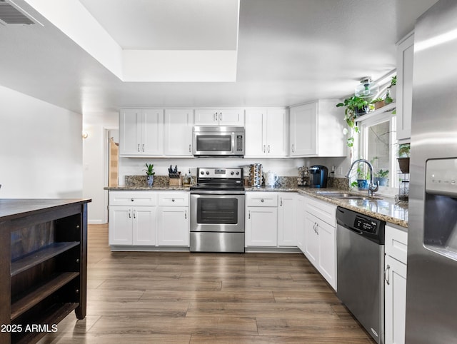 kitchen featuring sink, stainless steel appliances, and white cabinets