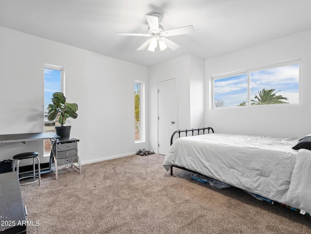 bedroom with multiple windows, carpet floors, and ceiling fan