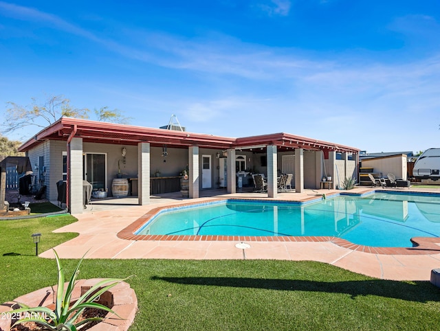 view of pool featuring a patio area and a lawn