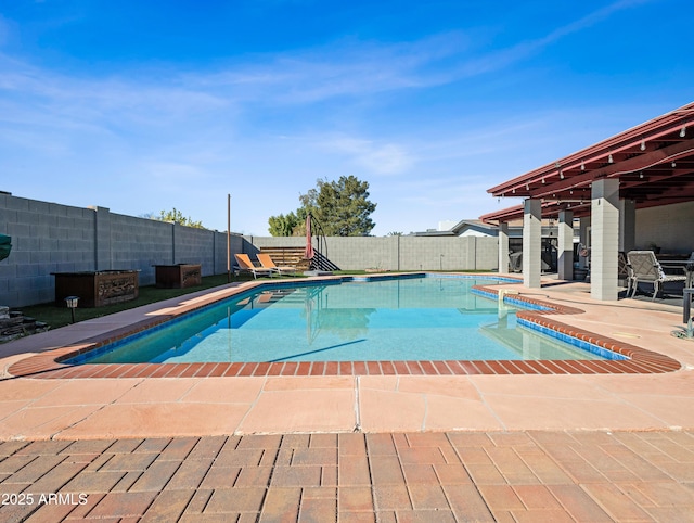 view of pool featuring a hot tub and a patio area