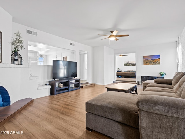 living room with ceiling fan and light hardwood / wood-style floors