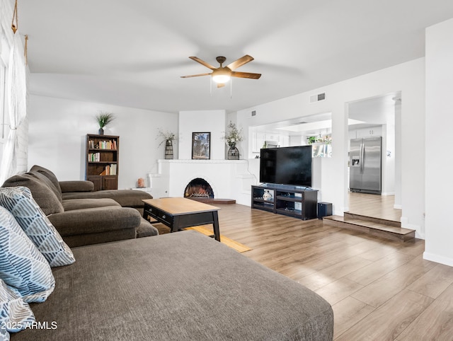 living room featuring hardwood / wood-style flooring and ceiling fan