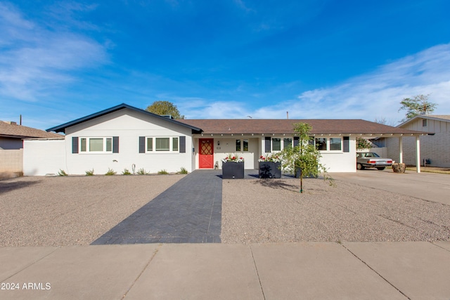 single story home featuring a carport