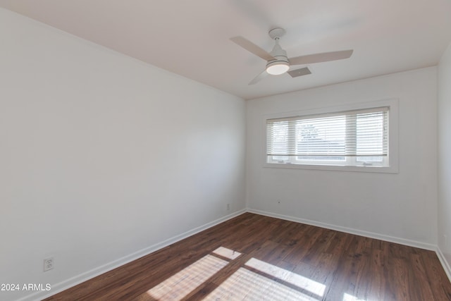 empty room featuring ceiling fan and dark hardwood / wood-style flooring