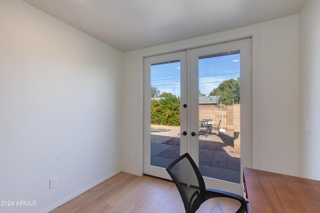 doorway featuring light wood-type flooring and french doors