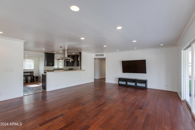 unfurnished living room featuring dark wood-type flooring and ornamental molding